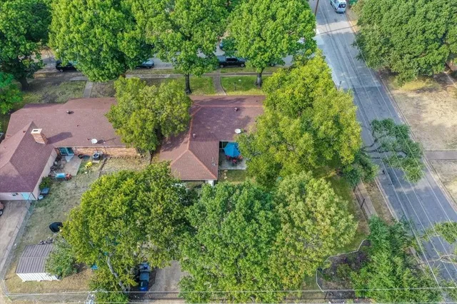 an aerial view of a house with a yard