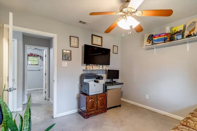 a kitchen with stainless steel appliances granite countertop a stove and a flat screen tv