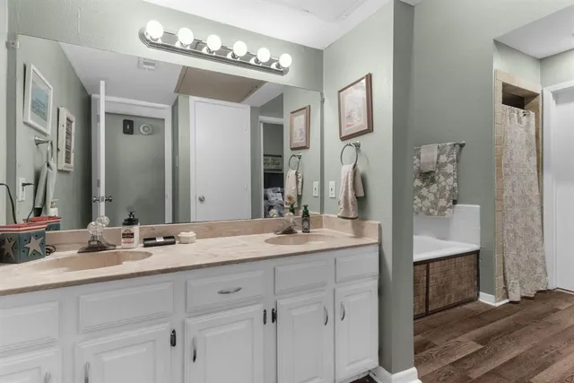 a bathroom with a double vanity sink and a mirror