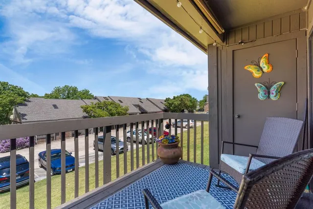 a balcony with furniture and wooden floor