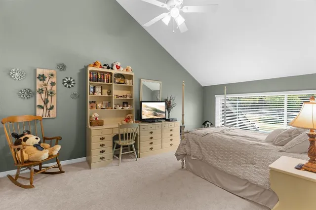 a bed room with furniture and a flat screen tv