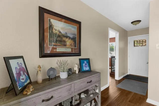a view of a workspace with furniture and wooden floor