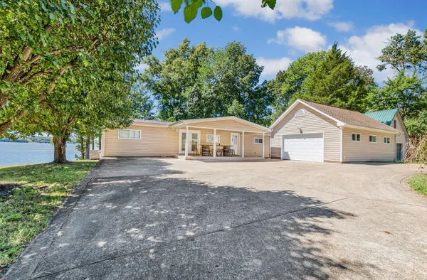 a view of house with outdoor space and trees around