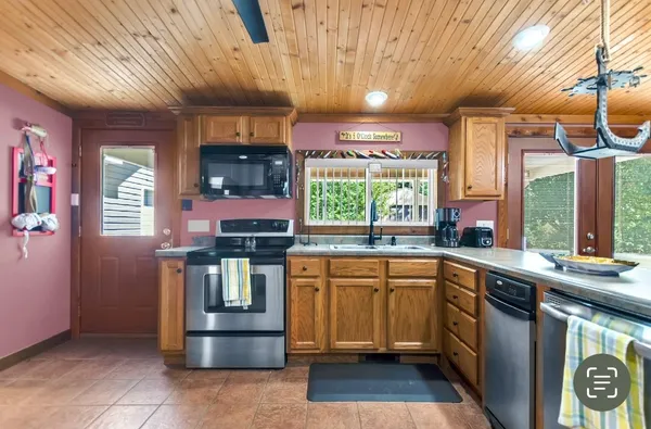 a kitchen with stainless steel appliances granite countertop a sink and a stove