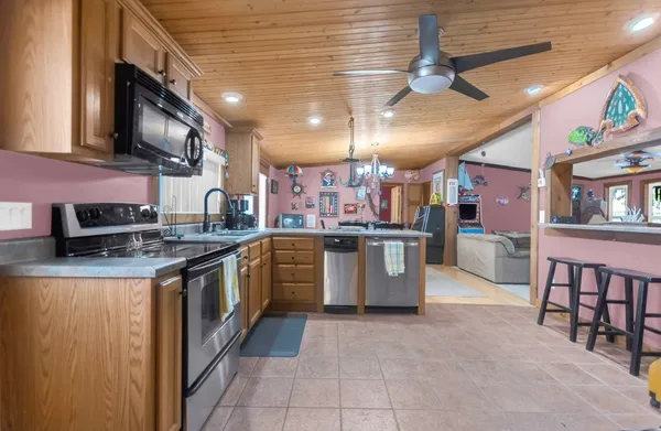 a kitchen with stainless steel appliances granite countertop a stove and a sink
