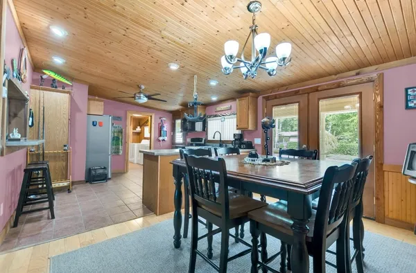 a view of a dining room with furniture and a chandelier