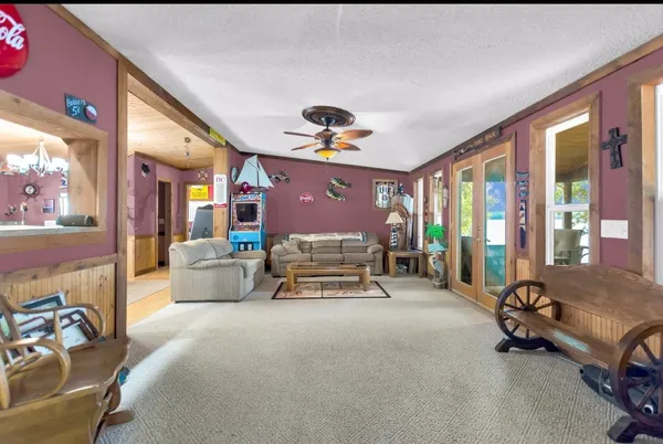 a living room with furniture and a chandelier