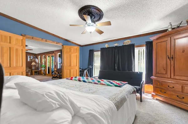 a bedroom with a bed and dresser with mirror