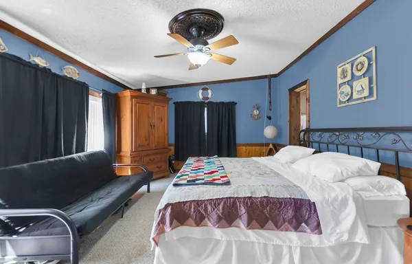 a bedroom with a bed and dresser