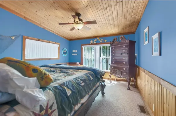 a bedroom with a bed and a chandelier