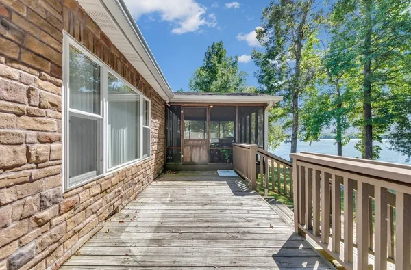 a balcony with wooden floor and furniture