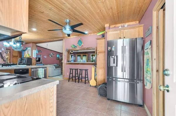a view of a kitchen with a refrigerator and a window