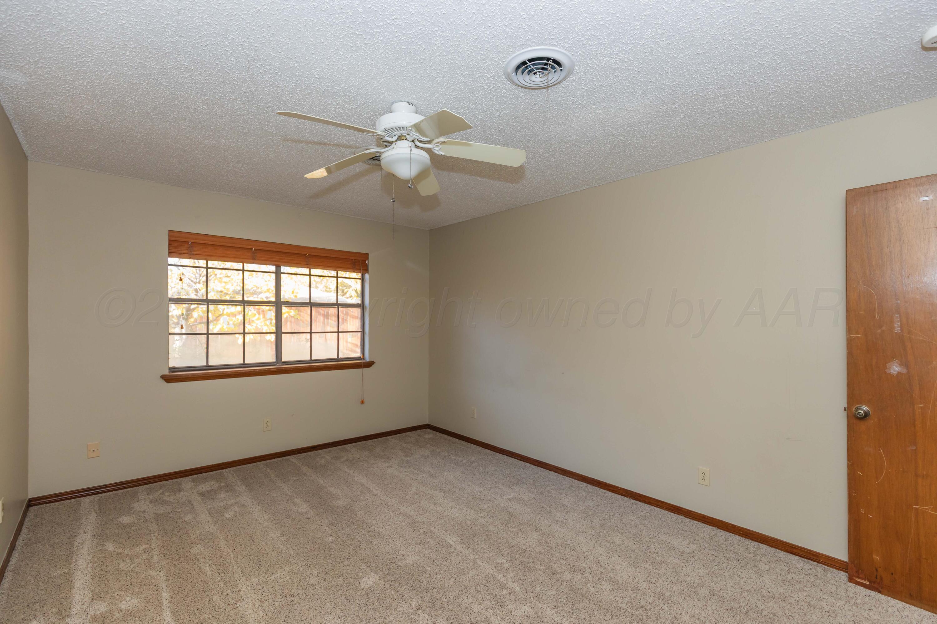 7805 Farrell Drive Amarillo, TX 79121 - Photo 11 of 20 an empty room with a window and a fan