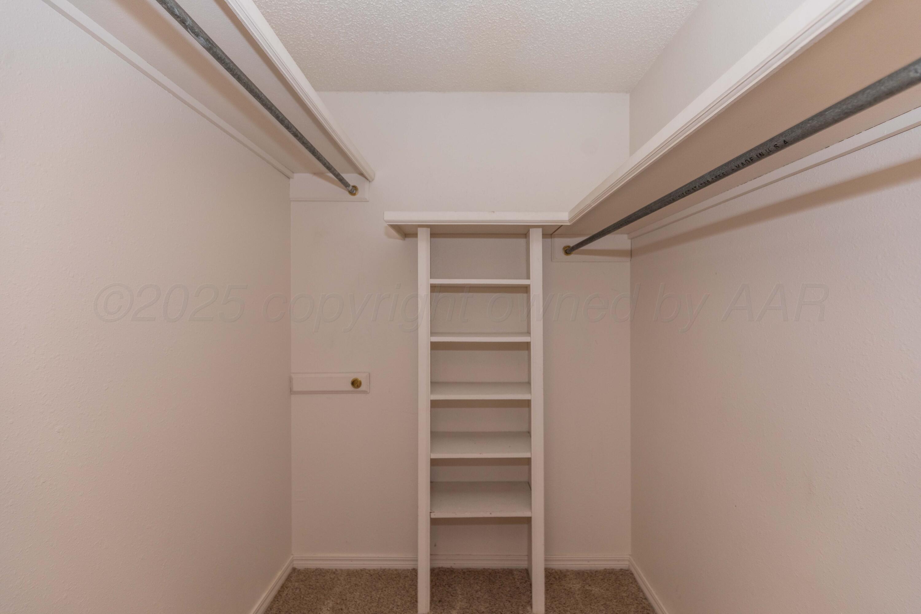 7805 Farrell Drive Amarillo, TX 79121 - Photo 16 of 20 a view of walk in closet with empty racks