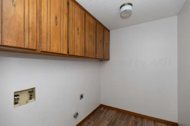 a view of storage and utility room with wooden floor