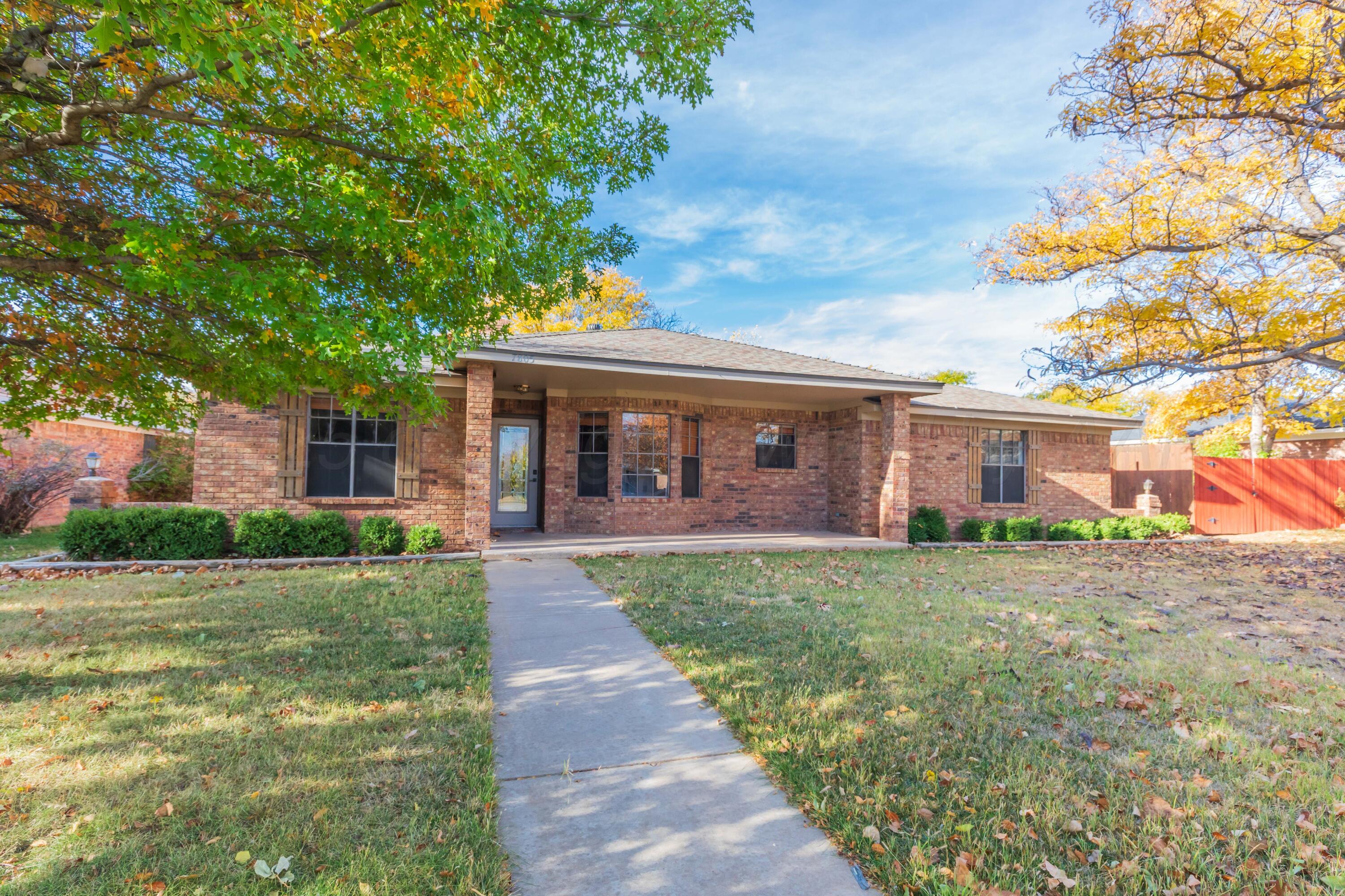 7805 Farrell Drive Amarillo, TX 79121 - Photo 2 of 20 a view of a yard in front of a house with a large tree
