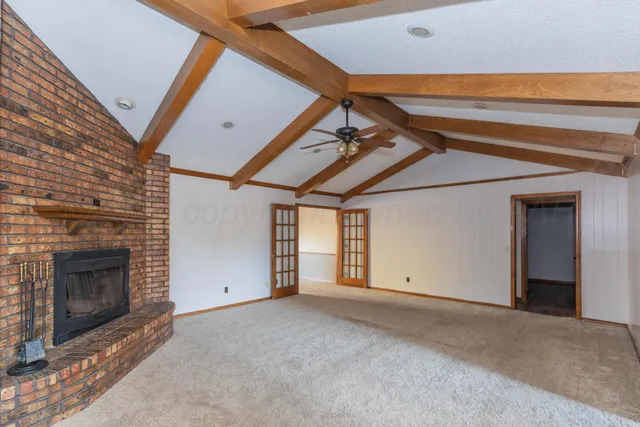 a view of empty room with a fireplace