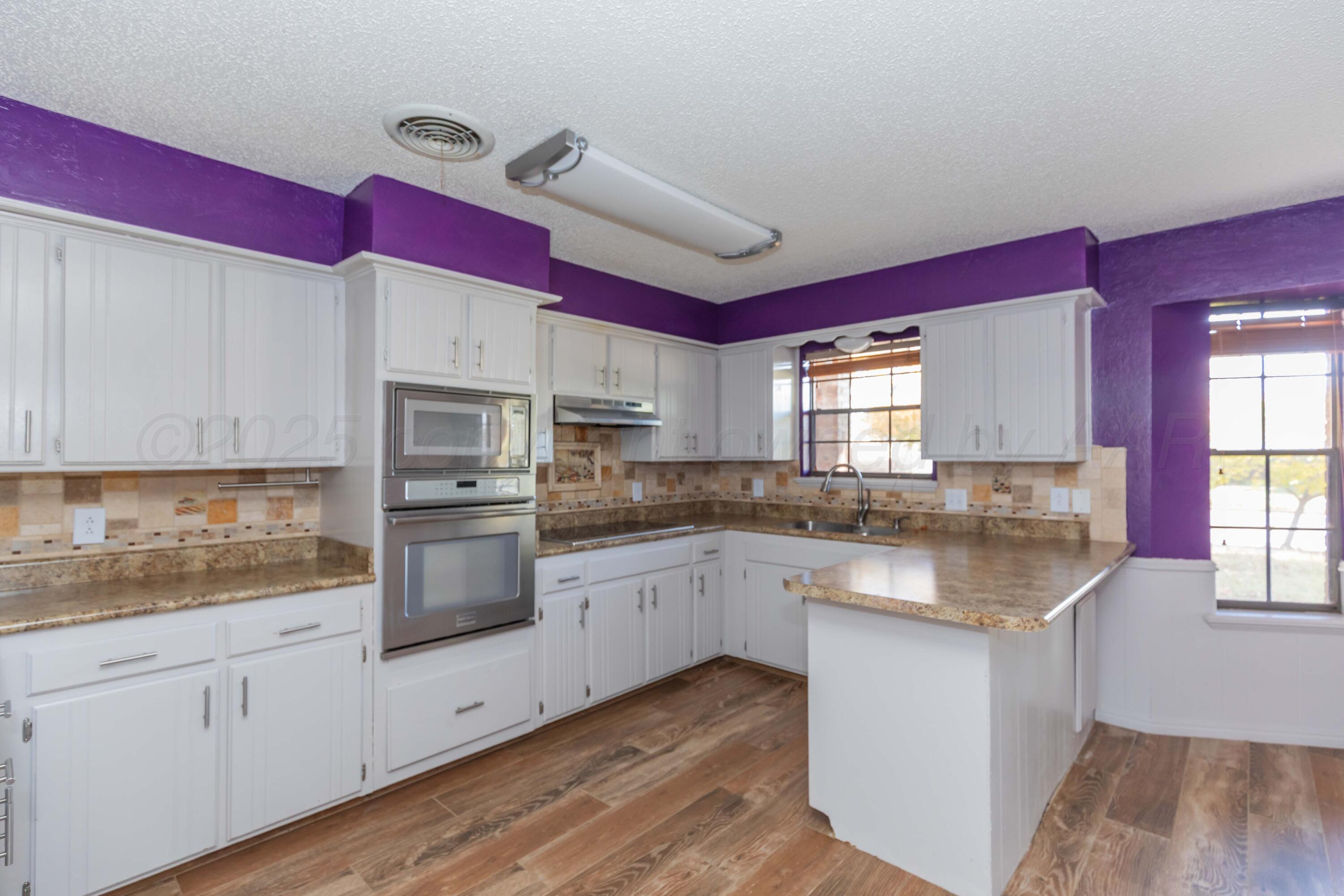 7805 Farrell Drive Amarillo, TX 79121 - Photo 5 of 20 a kitchen with granite countertop stainless steel appliances sink and cabinets