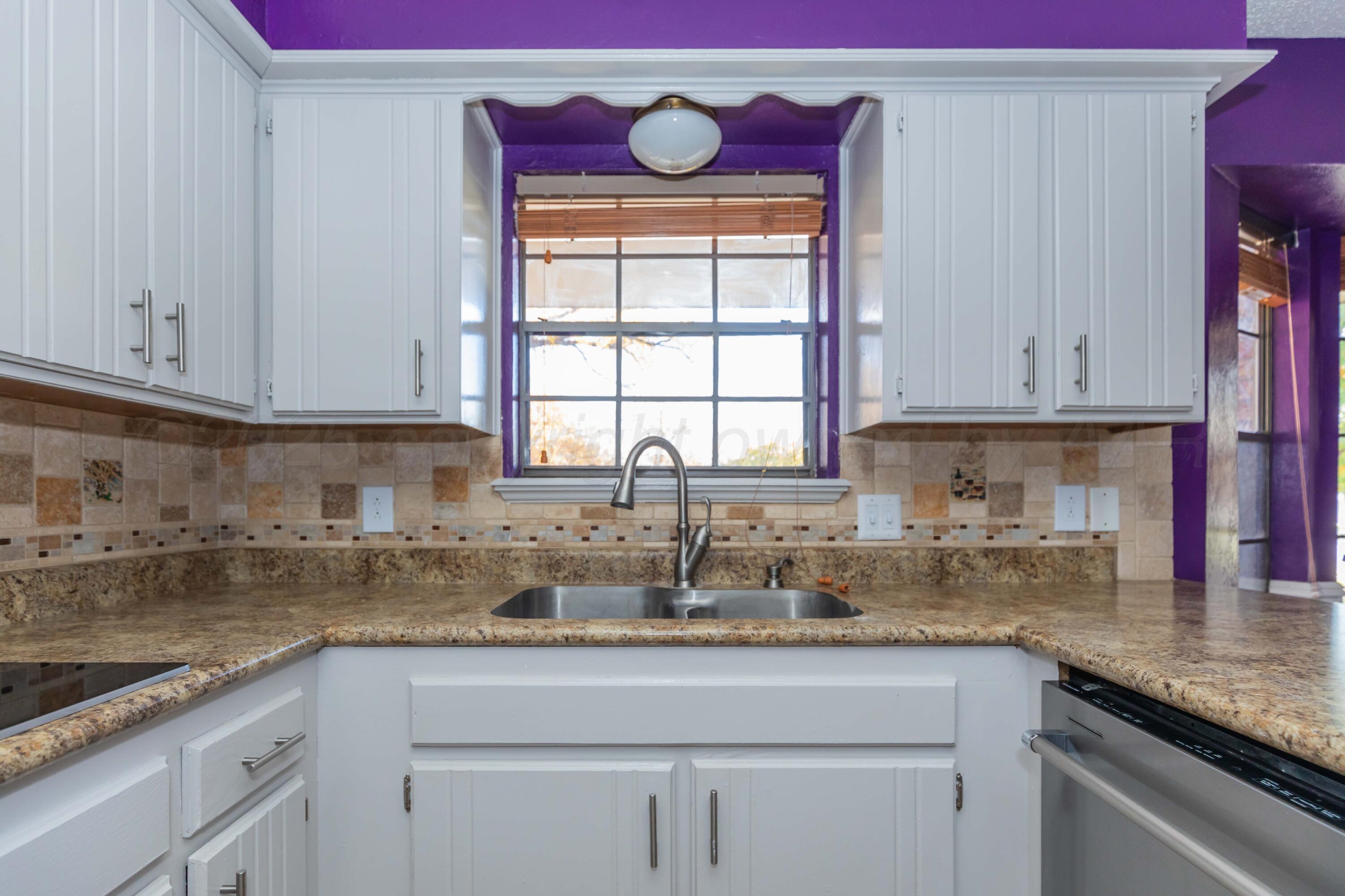 7805 Farrell Drive Amarillo, TX 79121 - Photo 6 of 20 a kitchen with stainless steel appliances granite countertop a sink a stove and cabinets