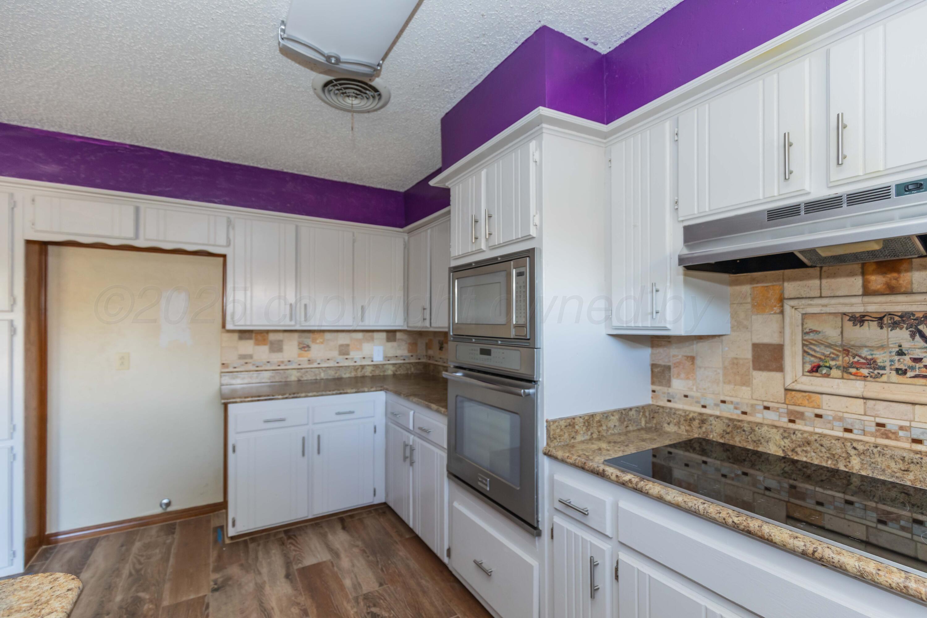 7805 Farrell Drive Amarillo, TX 79121 - Photo 7 of 20 a kitchen with stainless steel appliances granite countertop a sink stove and cabinets
