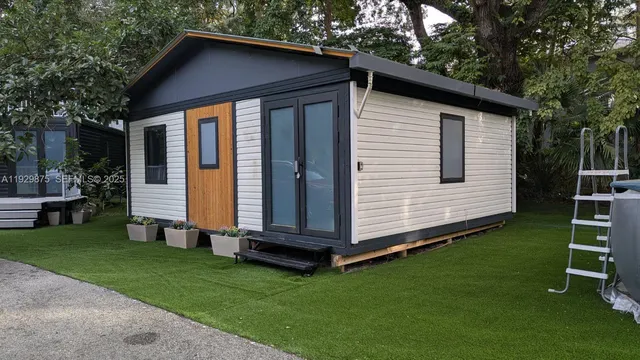 a view of a small house with a yard