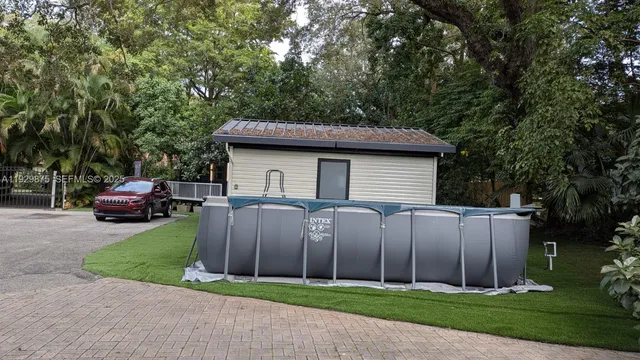 a front view of a house with a garden and trees