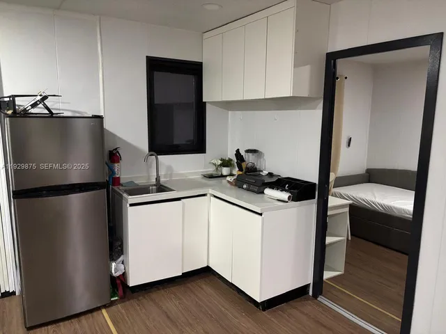 a kitchen with a refrigerator sink and stove
