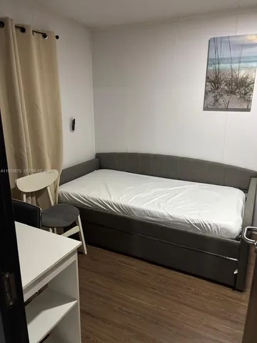 a bedroom with a bed and a mirror