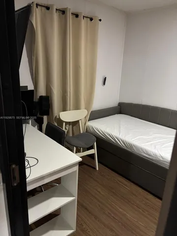 a bed sitting in a bedroom next to a window