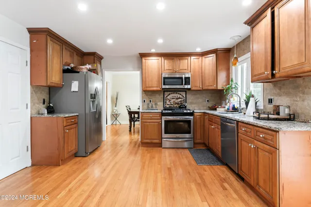 a kitchen with stainless steel appliances a refrigerator sink and cabinets