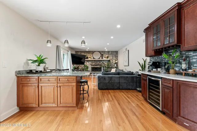a kitchen with stainless steel appliances granite countertop a stove a sink dishwasher and cabinets with wooden floor