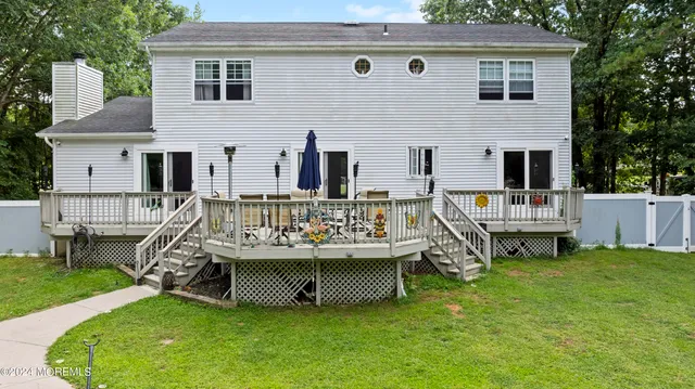 a view of a house with a chairs in a patio