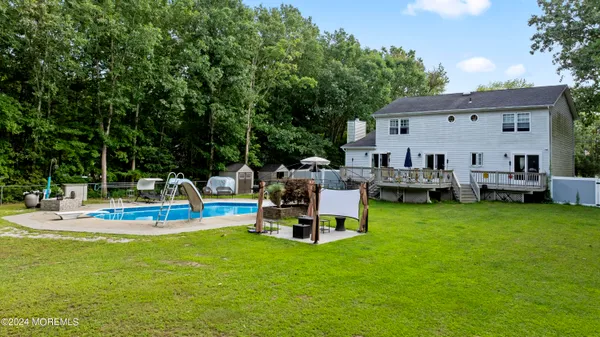 a view of a house with backyard porch and sitting area