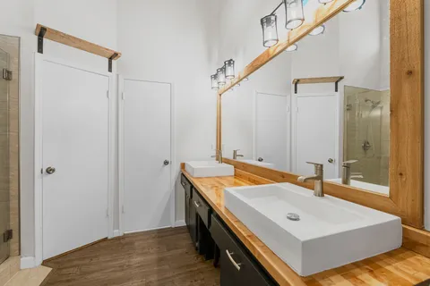 a bathroom with a tub sink and mirror