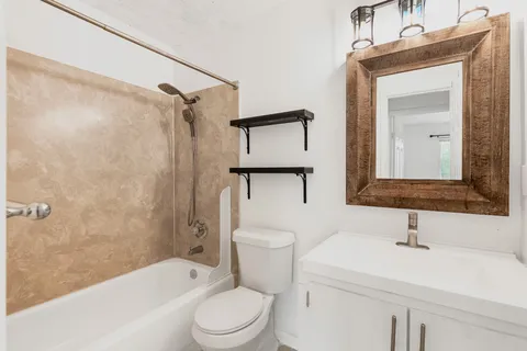 a bathroom with a toilet a sink and a bathtub