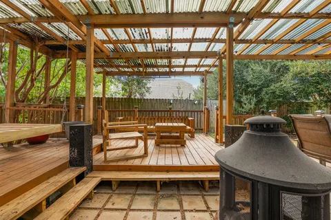 a view of a patio with table and chairs and wooden floor