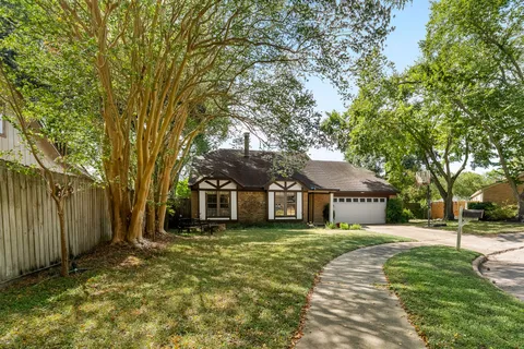 a front view of a house with a yard table and chairs