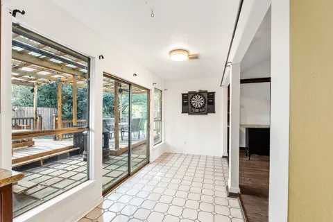 a view of a hallway with wooden floor and door