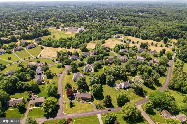 an aerial view of a house with a yard and swimming pool
