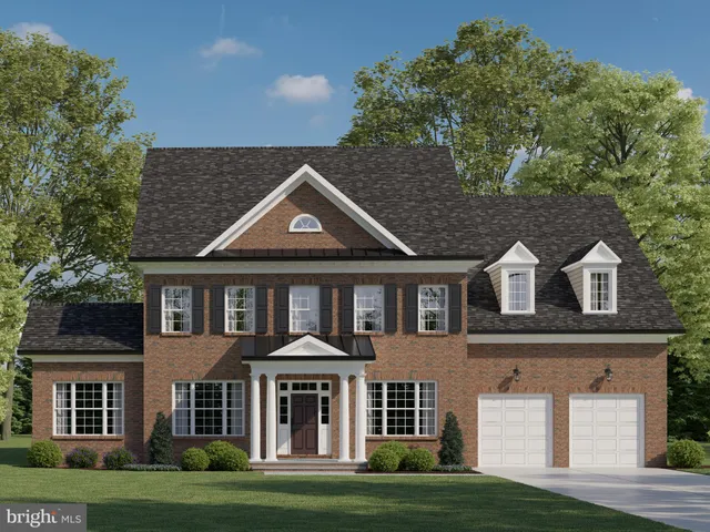 front view of a brick house with a yard