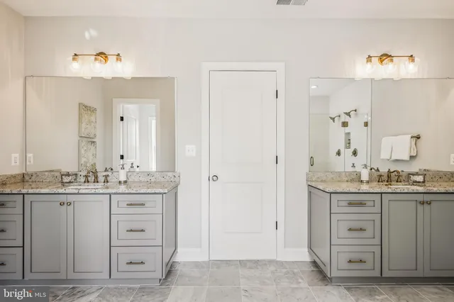 a kitchen with granite countertop wooden cabinets and a sink