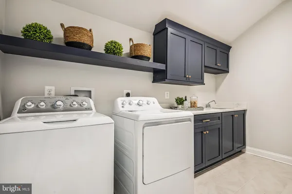 a bathroom with a granite countertop sink a toilet a mirror and shower