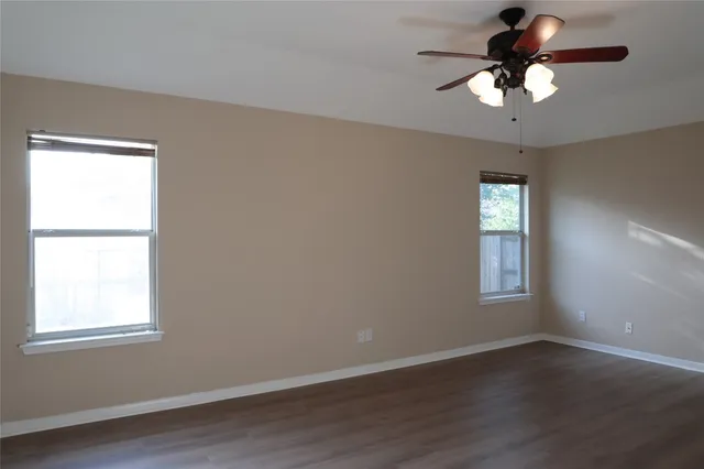 a view of a room with wooden floor and a window