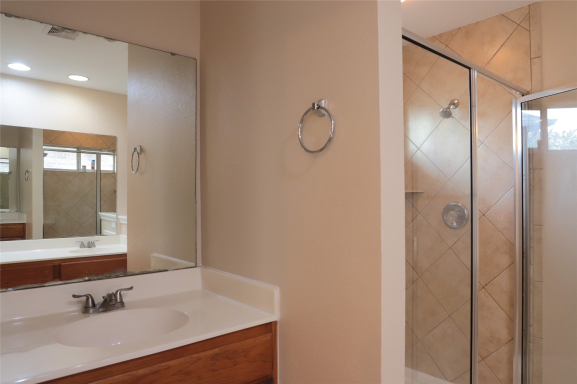 3936 Links Lane Round Rock, TX 78664 - Photo 24 of 40 a bathroom with a double vanity sink mirror and shower