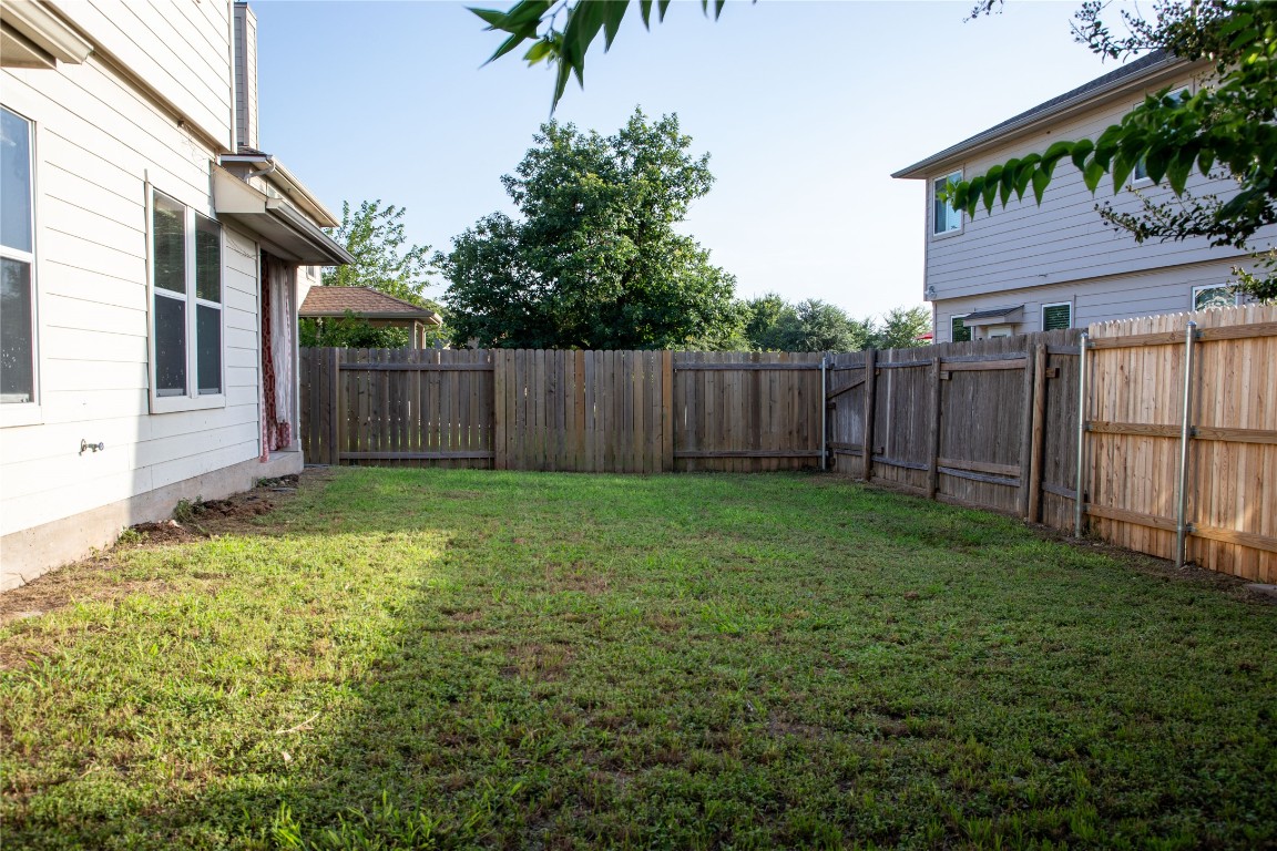 3936 Links Lane Round Rock, TX 78664 - Photo 37 of 40 a view of backyard with potted plants and wooden fence