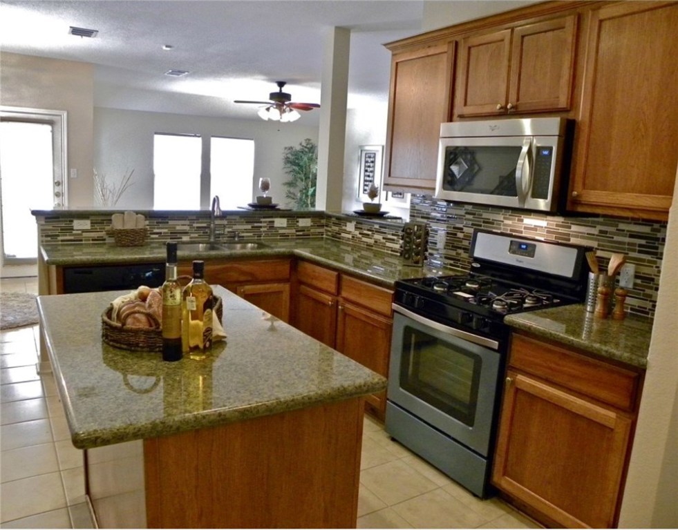 3936 Links Lane Round Rock, TX 78664 - Photo 4 of 40 a kitchen with a stove and a sink