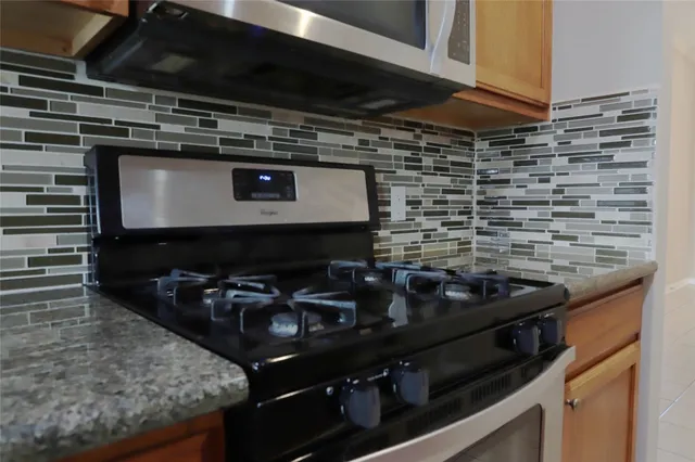a kitchen with a stove and a microwave