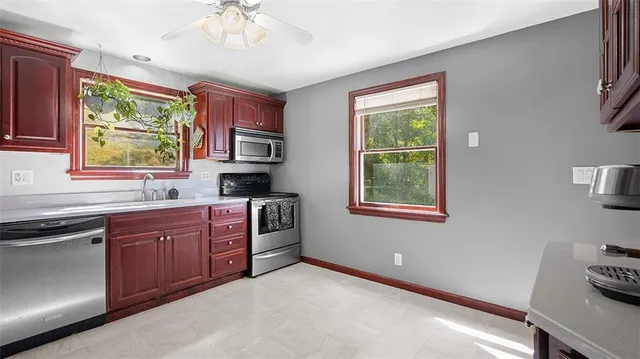 a kitchen with stainless steel appliances granite countertop a stove sink and cabinets