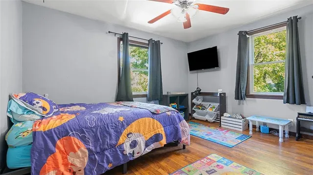 a bedroom with a bed and flat screen tv