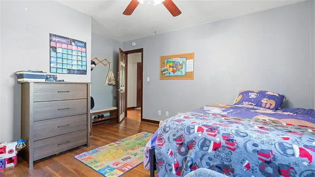 a bedroom with a bed and a bookshelf